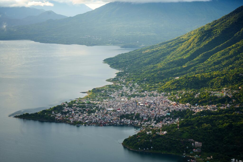 Stunning aerial shot of Lake Atitlán and a nearby town nestled among lush mountains.